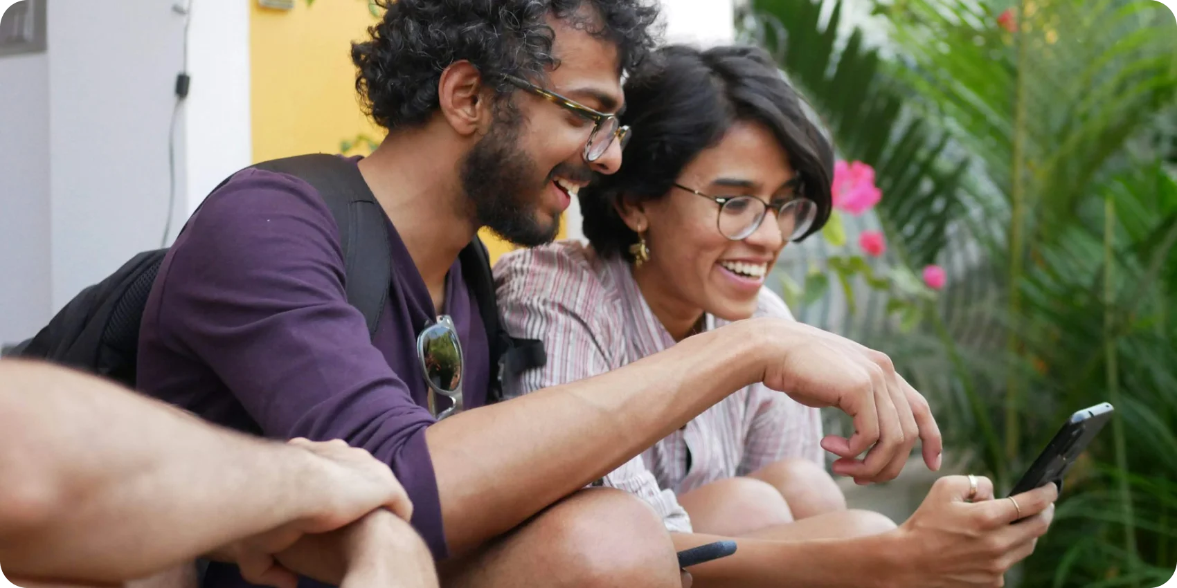 Two shoppers smiling at a phone together